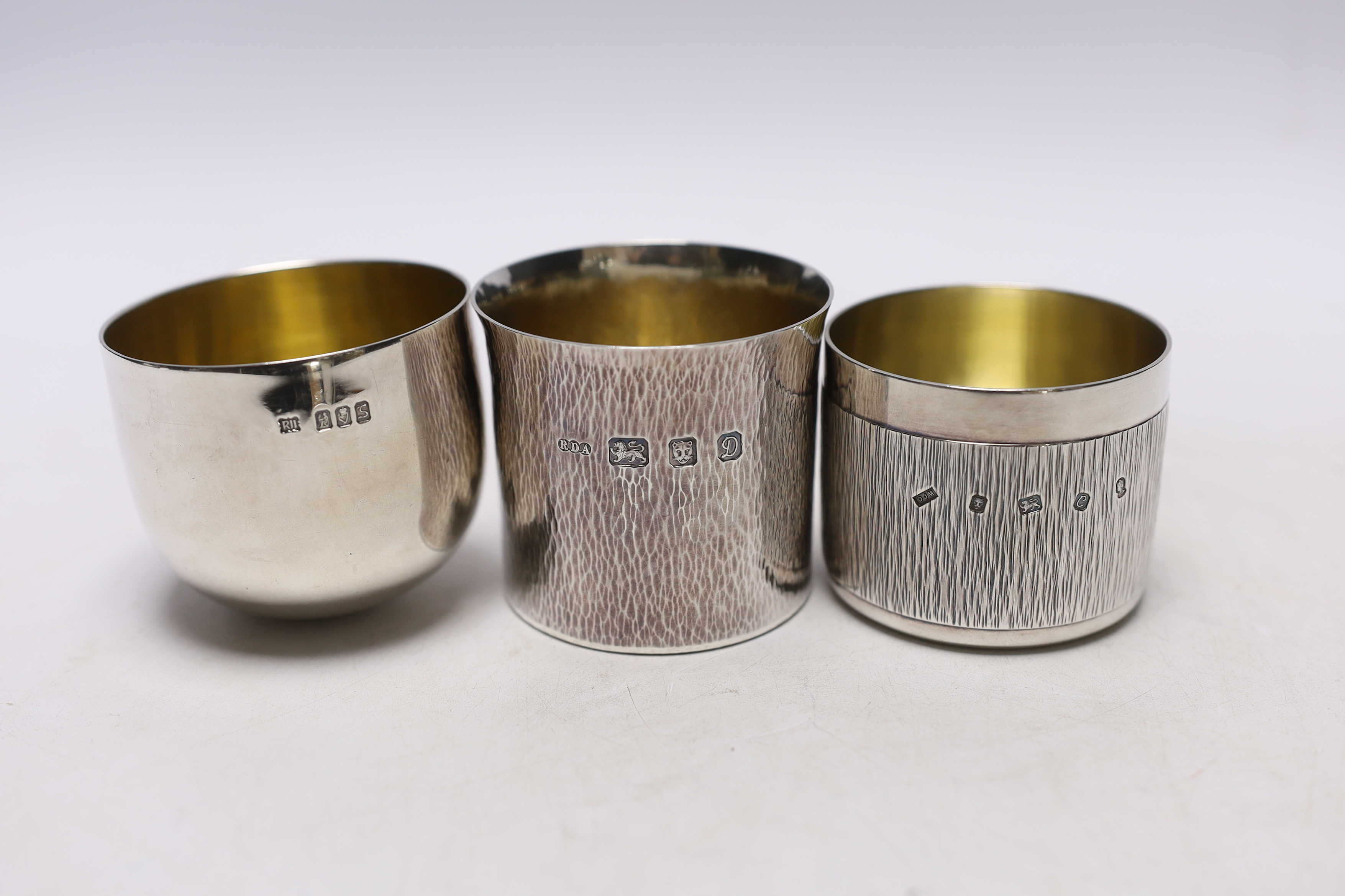 A modern Irish silver tumbler cup by Royal Irish Silver Co, height 59mm and two other modern silver beakers, 11.5oz.